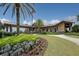 Lush landscaping at the front entrance of the golf clubhouse on a sunny day at 7643 Haddington Cv, Bradenton, FL 34202