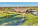 Aerial view of the impressive clubhouse and landscaping on the manicured golf course at 7643 Haddington Cv, Bradenton, FL 34202