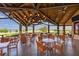 Charming clubhouse patio with stylish lighting, seating, and a view of the golf course at 7643 Haddington Cv, Bradenton, FL 34202