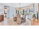 Elegant dining room with round table, seating for six, chandelier, and large bright windows at 7643 Haddington Cv, Bradenton, FL 34202