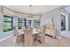 Bright dining room with a round table and seating, a chandelier, and sunlit views at 7643 Haddington Cv, Bradenton, FL 34202