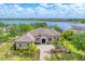 Stunning waterfront home with lush landscaping and a paver driveway, offering luxury and curb appeal at 7643 Haddington Cv, Bradenton, FL 34202