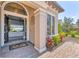 Elegant front entrance showcasing the landscaping, the stone walkway, and open doorway leading to the inviting interior at 7643 Haddington Cv, Bradenton, FL 34202