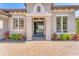 Inviting front entrance with a beautiful stone walkway, lush landscaping, and a glimpse into the light-filled interior at 7643 Haddington Cv, Bradenton, FL 34202