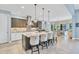 Stylish kitchen with a large island, pendant lighting, stainless steel appliances, and seamless access to the dining area at 7643 Haddington Cv, Bradenton, FL 34202
