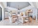 Open living room with plush seating, a ceiling fan, and easy access to the dining area and other parts of the home at 7643 Haddington Cv, Bradenton, FL 34202