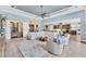 Inviting living room with comfortable seating, a decorative ceiling fan, and an open floor plan connecting to the kitchen at 7643 Haddington Cv, Bradenton, FL 34202
