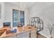 Classic office features a large wooden desk, shelving, and shuttered windows at 7643 Haddington Cv, Bradenton, FL 34202