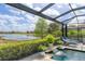 Enjoy lake views while relaxing in a lounge chair beside your beautiful pool at 7643 Haddington Cv, Bradenton, FL 34202