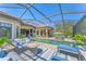 Inviting screened pool area with lounge seating and a cozy outdoor fire pit at 7643 Haddington Cv, Bradenton, FL 34202