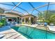 A beautiful screened-in pool with inviting lounge area, accessible from the interior of the home at 7643 Haddington Cv, Bradenton, FL 34202