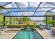 Stunning view from the screened-in pool area with lake vista at 7643 Haddington Cv, Bradenton, FL 34202