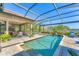 Gorgeous pool and patio with lake view, outdoor kitchen, and ample seating space at 7643 Haddington Cv, Bradenton, FL 34202
