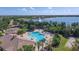 Aerial view of a free-form pool, spa, and lakeside homes with a fountain in a beautiful community at 7643 Haddington Cv, Bradenton, FL 34202