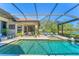Beautiful pool area with a screened-in lanai, lounge chairs, and tranquil water view at 7643 Haddington Cv, Bradenton, FL 34202