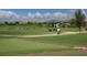Manicured putting green with golfers and neatly kept lawns, offering a serene and active lifestyle at 7643 Haddington Cv, Bradenton, FL 34202