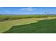 Spacious backyard featuring well-maintained lawn and stunning water views at 850 Tidewater Shores Loop # 202, Bradenton, FL 34208