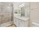 Beautiful bathroom featuring a tiled glass shower, a wide mirror, and great lighting at 850 Tidewater Shores Loop # 202, Bradenton, FL 34208