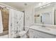 Bathroom with shower and tub combination featuring neutral tiles, white vanity and decorative mirror at 850 Tidewater Shores Loop # 202, Bradenton, FL 34208