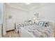 Twin bedroom featuring coastal décor, wood flooring, and neutral color scheme at 850 Tidewater Shores Loop # 202, Bradenton, FL 34208