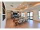 Bright living room featuring stylish seating, a large television, and direct access to an outdoor area at 850 Tidewater Shores Loop # 202, Bradenton, FL 34208