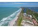 Gorgeous aerial view of oceanfront condos along a pristine sandy beach at 8710 Midnight Pass Rd # 202, Sarasota, FL 34242