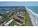 Aerial shot featuring waterfront condo buildings next to a beach and ocean at 8710 Midnight Pass Rd # 202, Sarasota, FL 34242