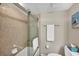 This bathroom features a shower and tub combination and neutral colored tile at 8710 Midnight Pass Rd # 202, Sarasota, FL 34242