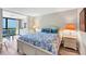 Comfortable bedroom with blue accents and easy access to the dining area and balcony at 8710 Midnight Pass Rd # 202, Sarasota, FL 34242