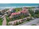 Aerial view of condominiums with red tile roofs, lush landscaping, and convenient parking at 8710 Midnight Pass Rd # 202, Sarasota, FL 34242