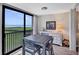 Bright dining area features beach views, and a gray dining table with seating for four at 8710 Midnight Pass Rd # 202, Sarasota, FL 34242