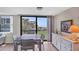 Bright dining area features beach views, dining table, and a white cabinet with decorative items at 8710 Midnight Pass Rd # 202, Sarasota, FL 34242