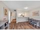 Well-lit and airy living room with hardwood floors open to the entry and kitchen, creating seamless transitions at 8710 Midnight Pass Rd # 202, Sarasota, FL 34242