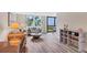 Comfortable living room with hardwood floors, neutral decor, and large windows offering partial beach views at 8710 Midnight Pass Rd # 202, Sarasota, FL 34242