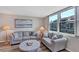 Inviting living room featuring comfortable seating, neutral decor, hardwood floors, and view of the beach at 8710 Midnight Pass Rd # 202, Sarasota, FL 34242
