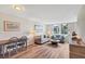 Cozy living room featuring hardwood floors, neutral paint, comfortable seating, and ocean view at 8710 Midnight Pass Rd # 202, Sarasota, FL 34242