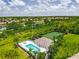 Aerial view showcasing the community pool, tennis courts, and lush surroundings at 6314 Bay Cedar Ln # 201, Bradenton, FL 34203