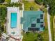 Aerial shot of the community pool and clubhouse, featuring solar panels on the roof, a hot tub, and lounging area at 6314 Bay Cedar Ln # 201, Bradenton, FL 34203