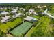 Aerial view of a community with tennis court and pool, surrounded by lush landscaping and mature trees at 6314 Bay Cedar Ln # 201, Bradenton, FL 34203