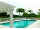 Community pool offers clear water, mature trees, and comfortable area for relaxation at 6314 Bay Cedar Ln # 201, Bradenton, FL 34203