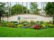 Entrance sign for Cypress Strand featuring well-manicured flowerbeds and green lawn at 6314 Bay Cedar Ln # 201, Bradenton, FL 34203