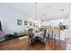 Open-concept dining area featuring a wicker table set, hardwood floors, and connection to the kitchen at 6314 Bay Cedar Ln # 201, Bradenton, FL 34203
