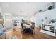 Open-concept dining area featuring a wicker table set, hardwood floors, and connection to the kitchen at 6314 Bay Cedar Ln # 201, Bradenton, FL 34203