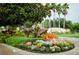 The Cypress Strand entrance showcases lush landscaping and colorful floral arrangements, providing a warm welcome at 6314 Bay Cedar Ln # 201, Bradenton, FL 34203