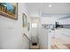 Entryway with staircase, and kitchen with white cabinets, granite countertops and stainless steel appliances at 6314 Bay Cedar Ln # 201, Bradenton, FL 34203