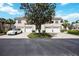 Townhouse exterior featuring multiple garages, front yard landscaping and a white car parked in the driveway at 6314 Bay Cedar Ln # 201, Bradenton, FL 34203