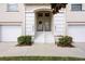 Inviting townhome entrance featuring a well-maintained walkway, landscaping, and unit numbers above each front door at 6314 Bay Cedar Ln # 201, Bradenton, FL 34203