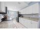 Bright kitchen with white cabinets, granite countertops, stainless steel appliances, and a breakfast nook at 6314 Bay Cedar Ln # 201, Bradenton, FL 34203