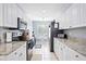 Bright kitchen with white cabinets, granite countertops, stainless steel appliances, and a breakfast nook at 6314 Bay Cedar Ln # 201, Bradenton, FL 34203