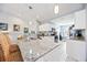 Bright kitchen with a large island, granite countertops, stainless steel appliances, and white cabinetry at 6314 Bay Cedar Ln # 201, Bradenton, FL 34203